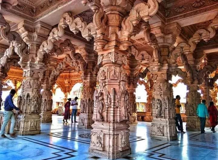 carved temple pillar and archway in pink sandstone Carved pink sandstone pillars at Sanwaliya Seth temple Mandfiya