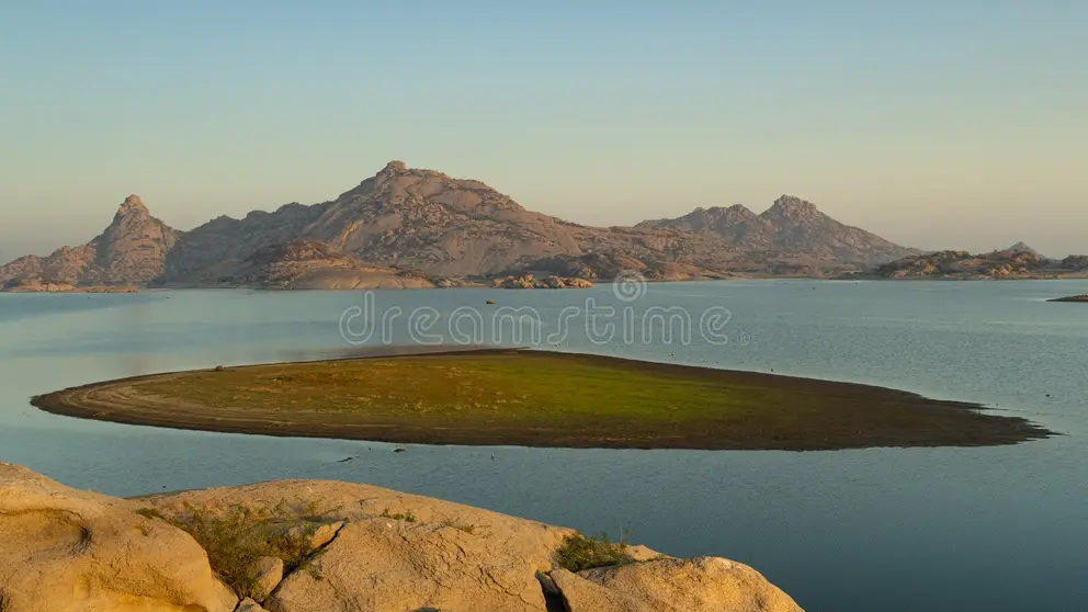 Jawai Dam reservoir at sunrise with granite hills in the background