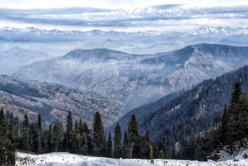 Himalayan mountain town called Narkanda at golden hour, deodar forest on the hillside, snow-capped peaks in the distance, Hidden gems near Narkanda seen from a forest viewpoint at golden hour