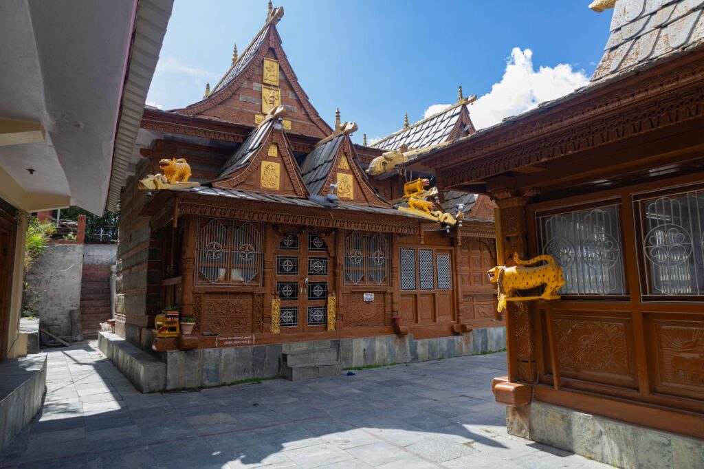 pexels-photo-38992913-38992913 Intricate traditional wood-carved Indian temple with vibrant decor.