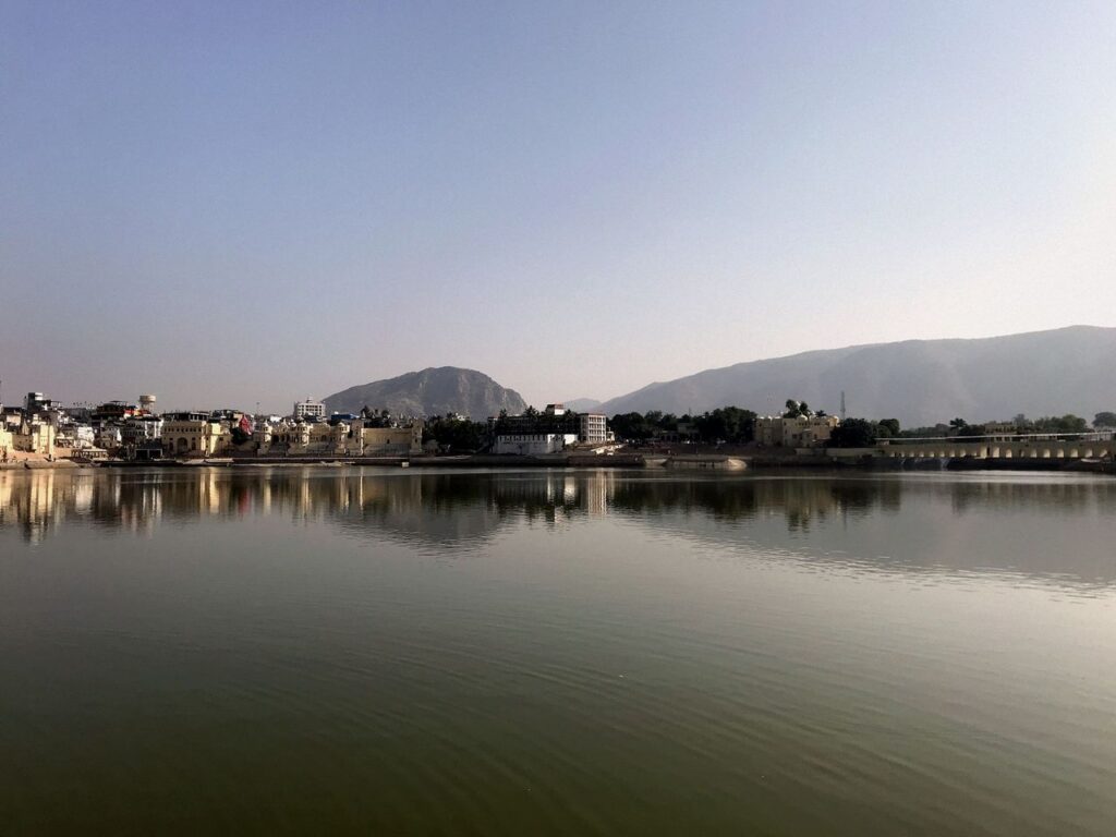 Beautiful morning view of Pushkar Lake with cityscape and mountains in India.