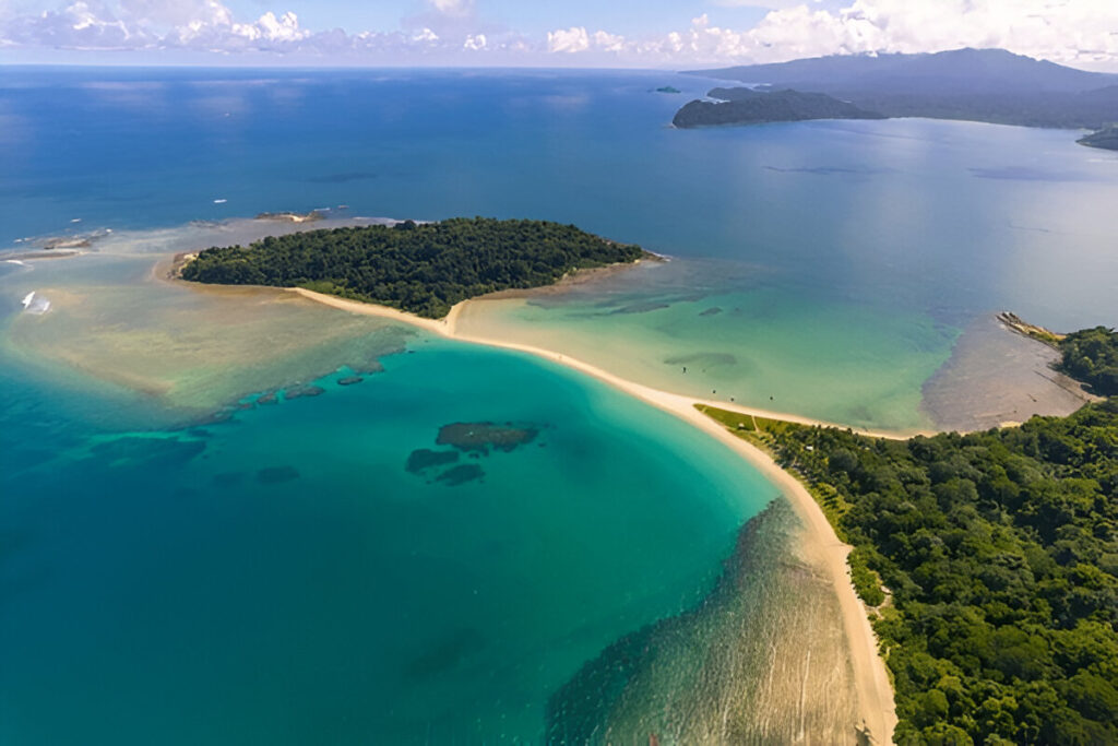 narrow white sandbar connecting two small forested tropical islands, turquoise water on both sides Sandbar joining Ross and Smith Islands, one of the top places to visit in Diglipur, North Andaman