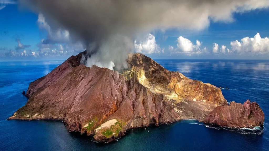 active volcano Traveller on deck at sunrise looking at Barren Island volcano during a day trip from Port Blair
