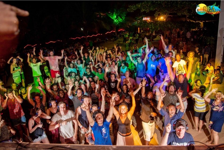  Travellers at a beach silent disco in Palolem, a fun idea among things to do in Goa at night